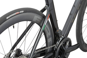 Close-up of the EVOLUZIONE 1s rear wheel and frame, showcasing aerodynamic design with disc brakes and visible chain mechanism.