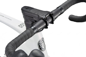 Close-up of EVOLUZIONE 1 handlebar with black grips and electronic display, on white frame featuring logo and text details.