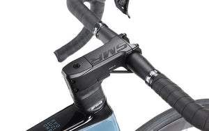 Close-up of the EVOLUZIONE 1s handlebars and stem by Masi Bikes, showcasing textured grips and a sleek, aerodynamic design. The modern branding on the top tube enhances this road bikes minimalistic and streamlined look.