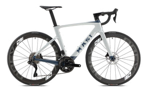 The Masi Bikes Evoluzione 1 is a sleek, modern road bike with a white and blue frame. It features aerodynamic design, disk brakes, and deep-section wheels. Masi Bikes is proudly displayed on the frame.