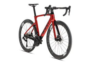 A sleek, red road bike with a modern aerodynamic design, drop handlebars, and black wheels featuring disc brakes. Masi Bikes is prominent on the frame, with Kenda tires for smooth rides. This stylish bike resembles the EVOLUZIONE 1 Carbon and stands against a plain white background.