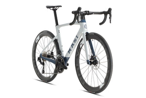 The Masi Bikes EVOLUZIONE 1 is a contemporary road bike featuring an aerodynamic design in white and blue. It includes drop handlebars, deep-profile wheels with disc brakes, and KENDA-branded tires.